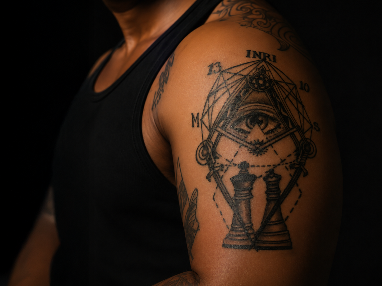 Tattoo on left arm — the seal of the book